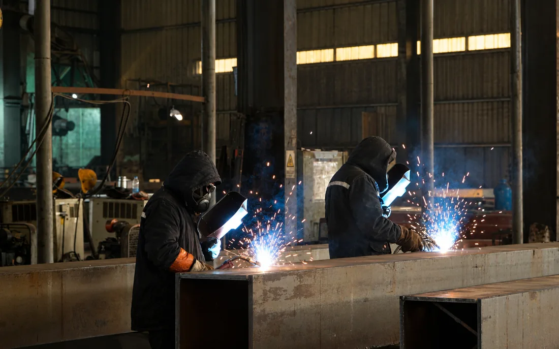 Welders at work on steel connections